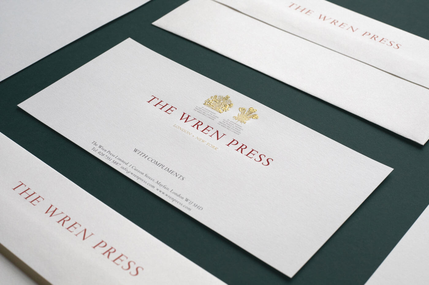 luxury compliment slip with gold crest logos printed on white paper