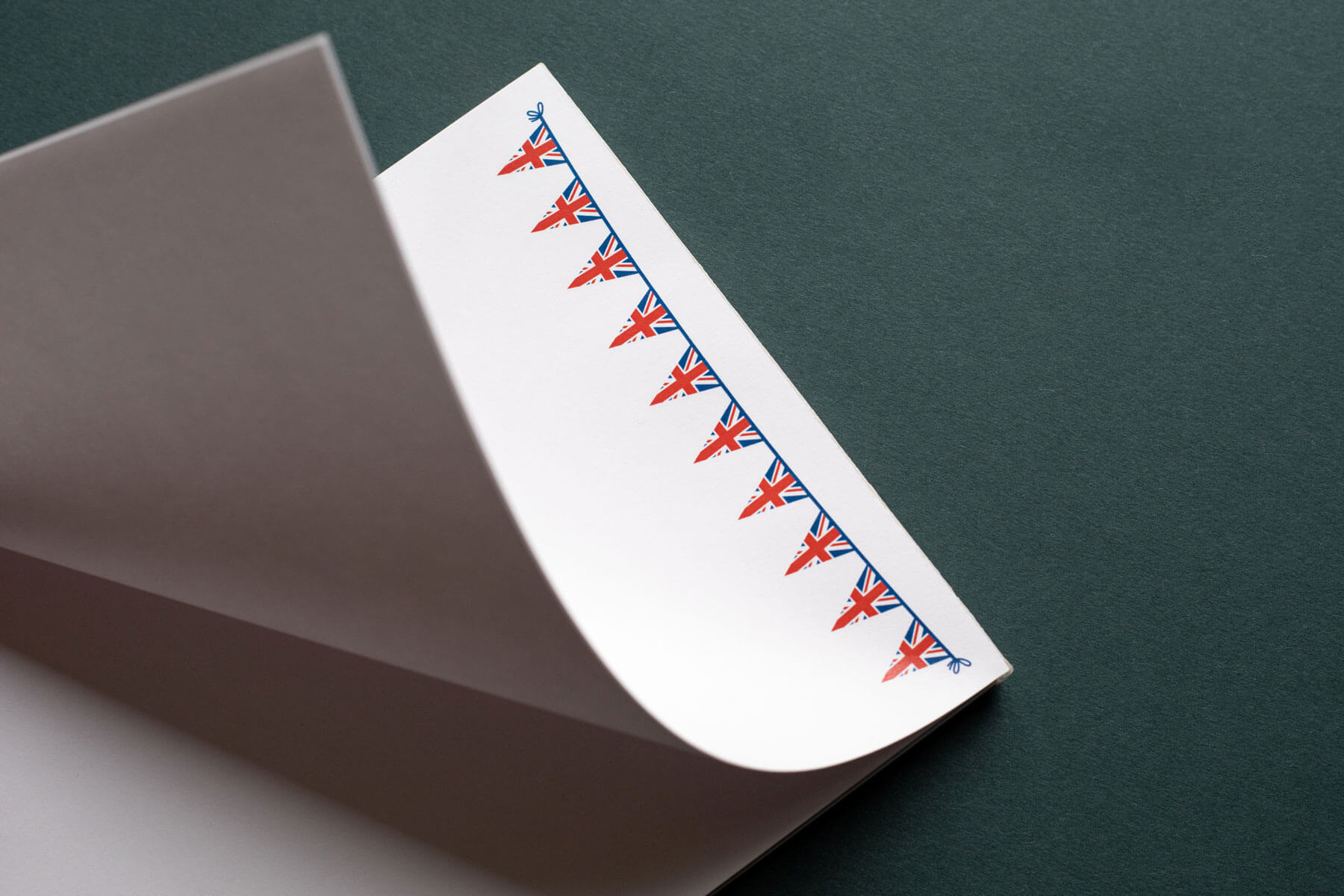 a notepad showing printed pages with a union jack flag bunting design